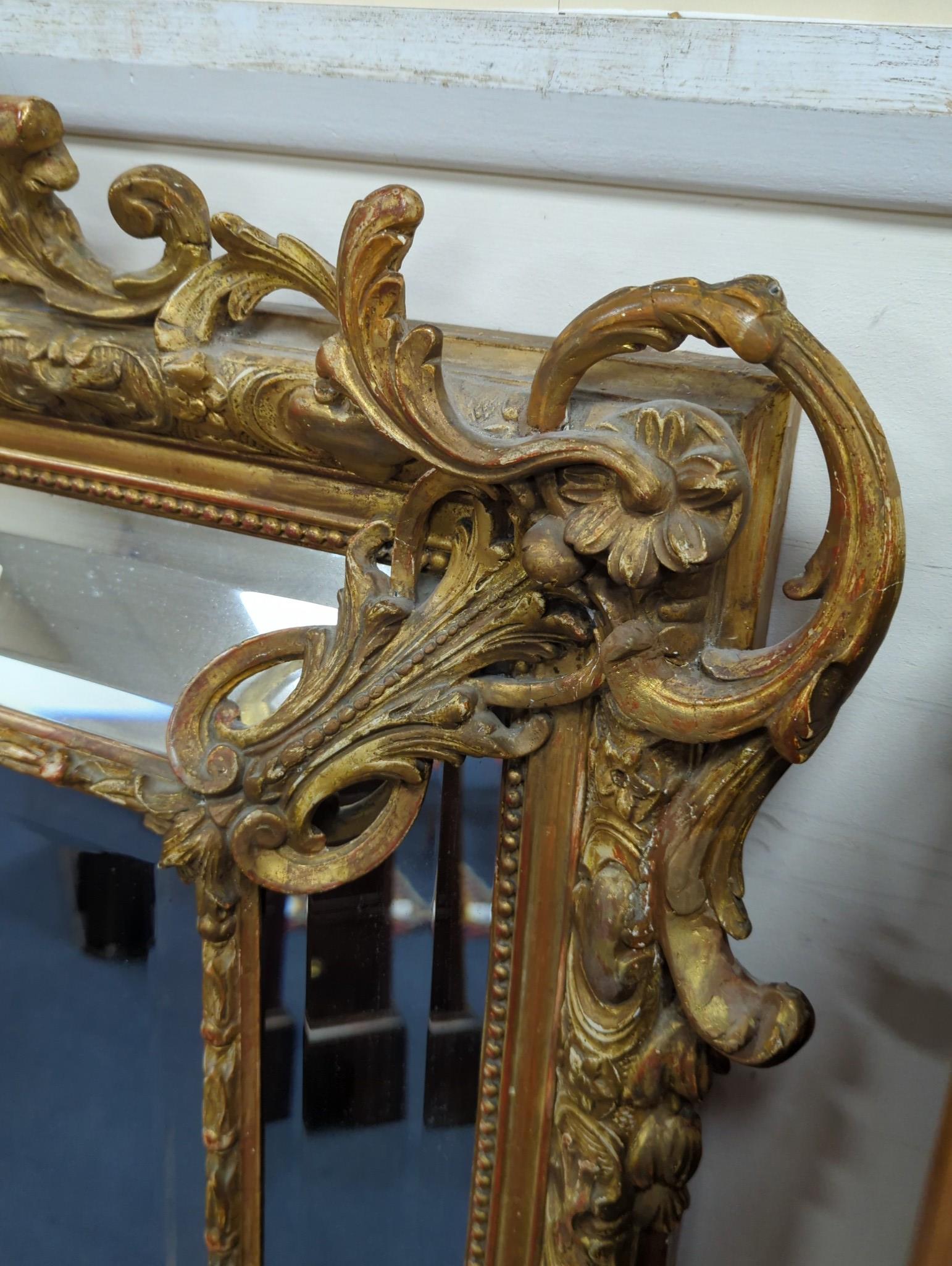 A large 19th century French gilt and gesso frame, bevel edged mirror with cushion margin, plated and C scroll, width 108cm, height 137cm